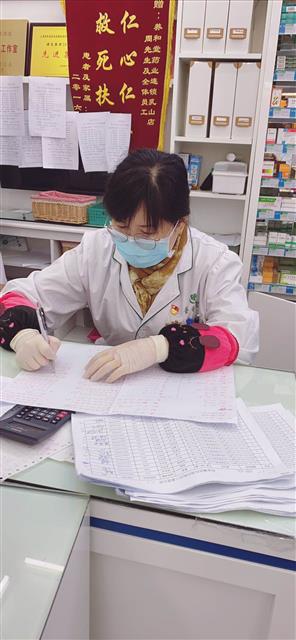 陸萍在統(tǒng)計口罩發(fā)放情況。